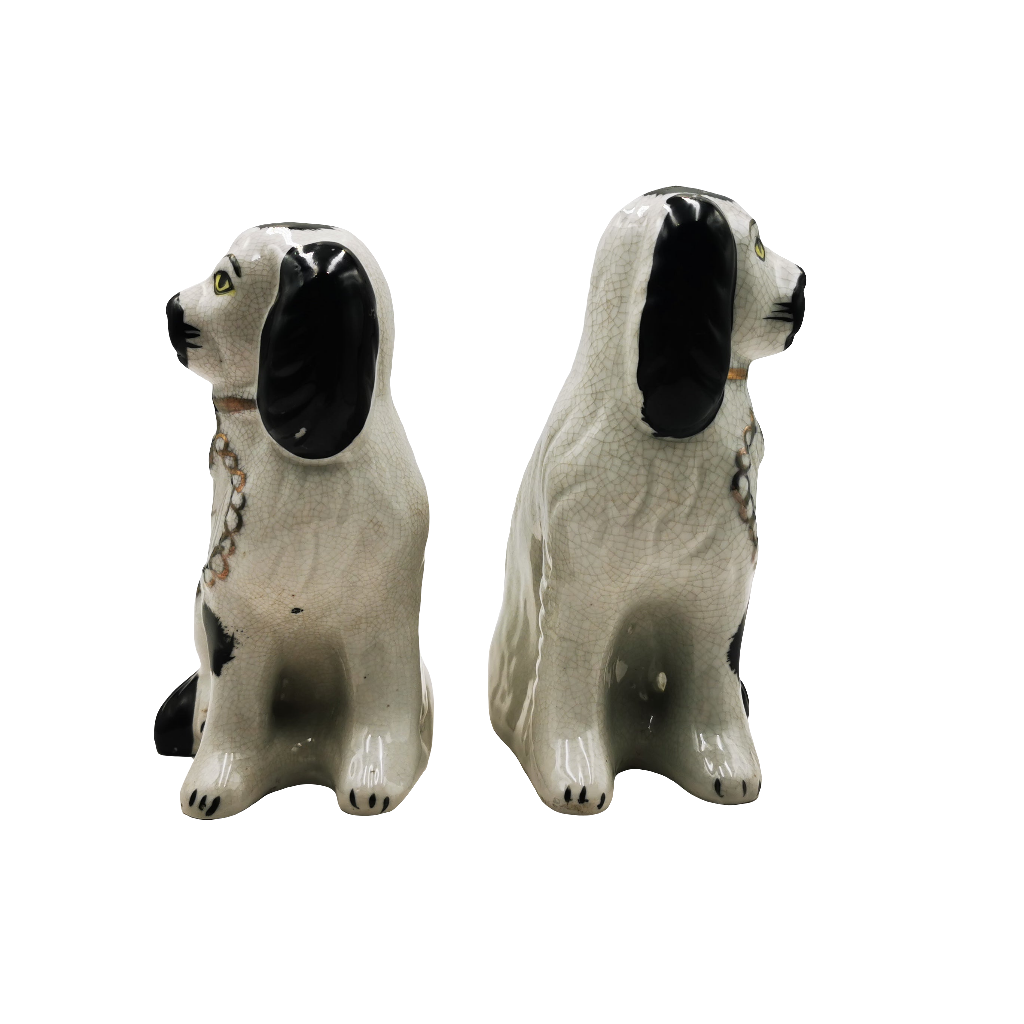 Two ceramic dog figurines on a white background